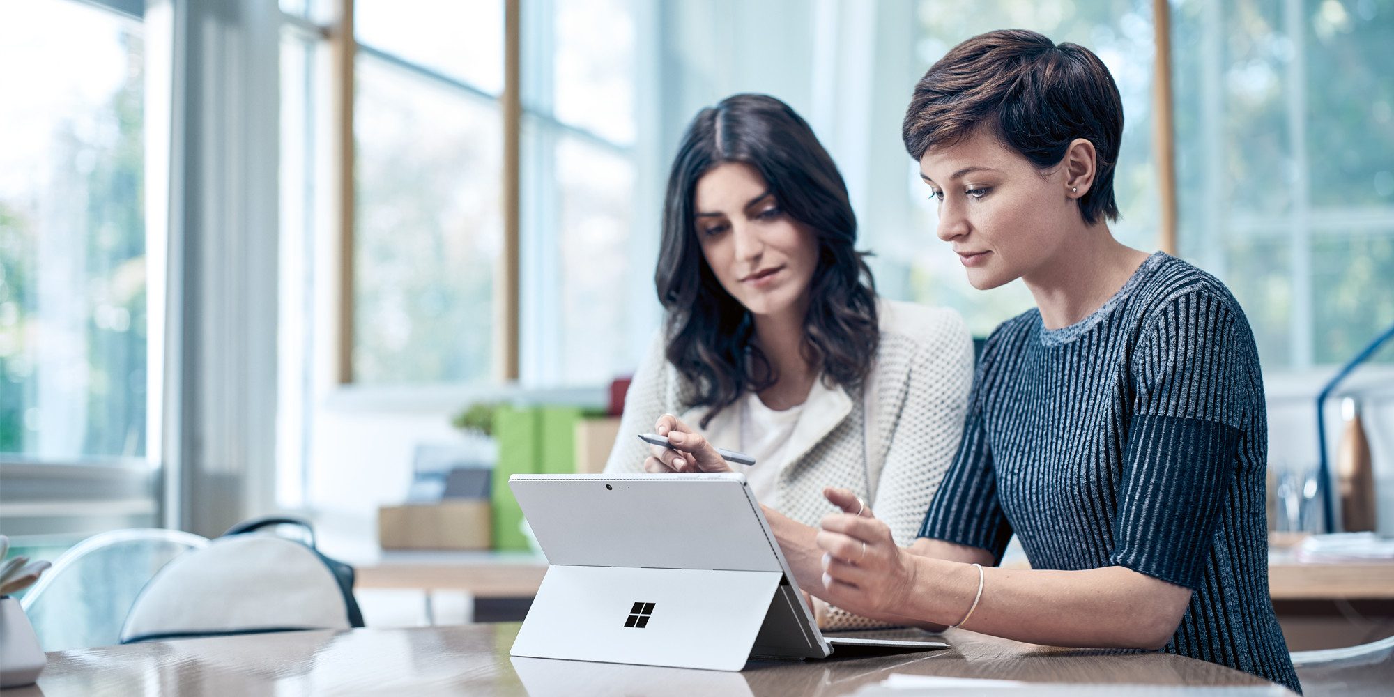 2 women working on a Microsoft Surface