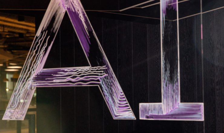 AI spelled in neon letters