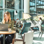Woman interacting with an Asus NovaGo laptop. 