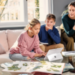 Family, mother and 2 student kids at home working, typing on Surface Go