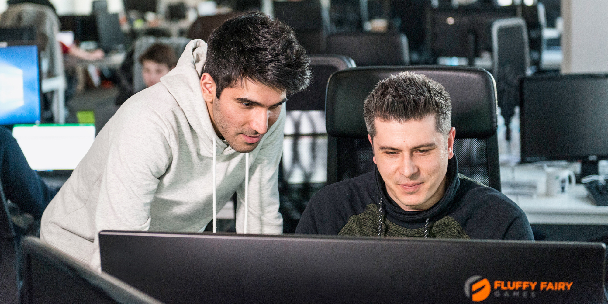 a man sitting in front of a laptop computer