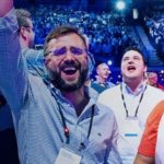 a group of people standing in front of a crowd posing for the camera