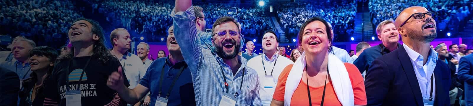a group of people standing in front of a crowd posing for the camera
