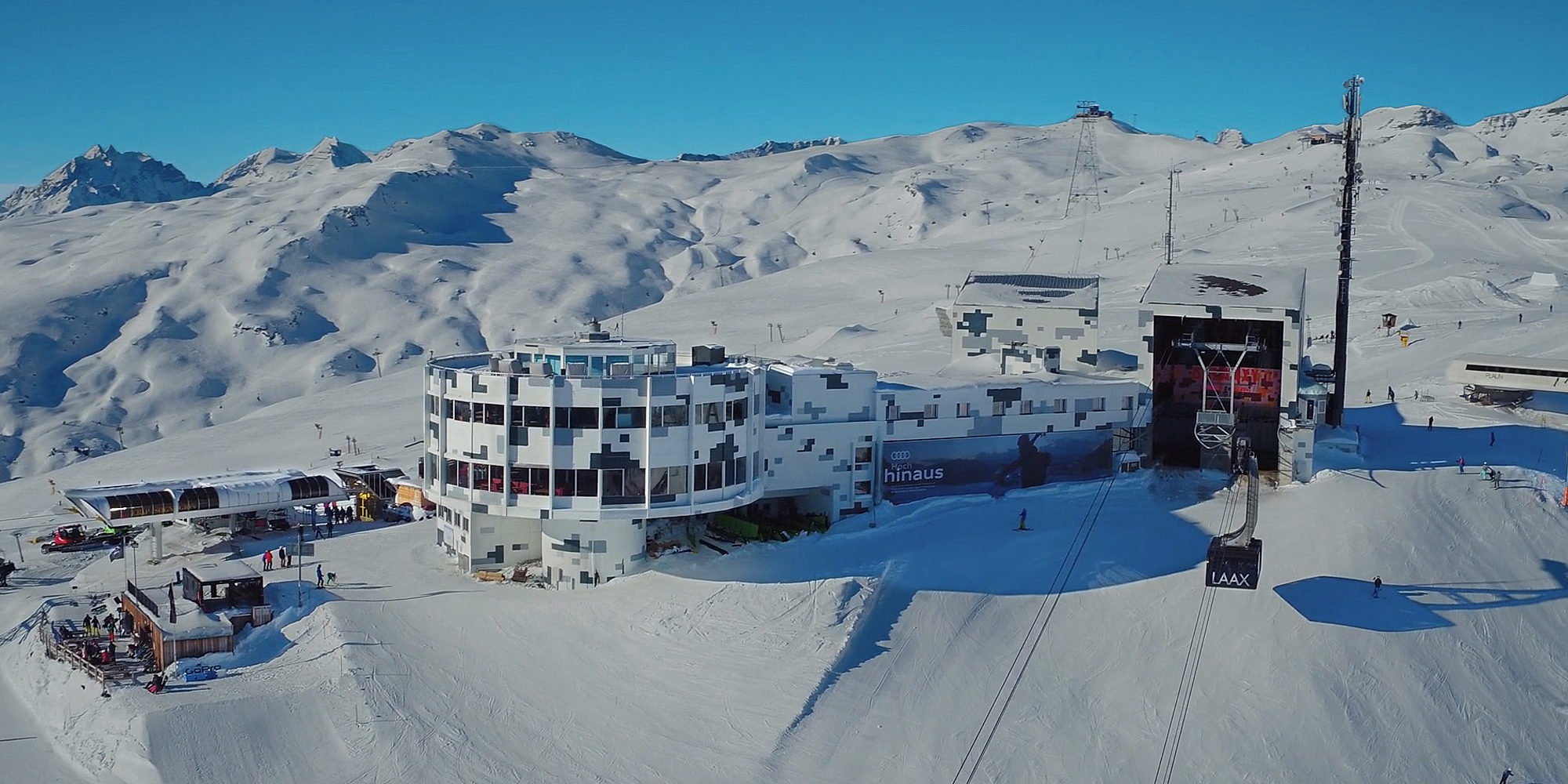 a group of people standing on top of a snow covered mountain
