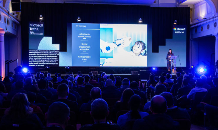 a group of people on a stage in front of a crowd