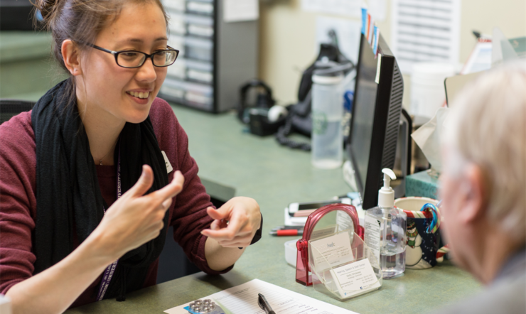 Medical assistant advising patient
