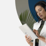 Standing woman writing on a Surface tablet