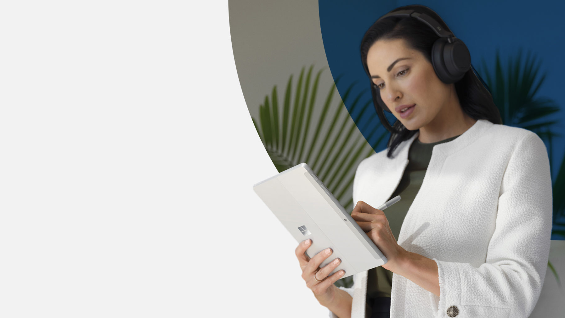 Standing woman writing on a Surface tablet
