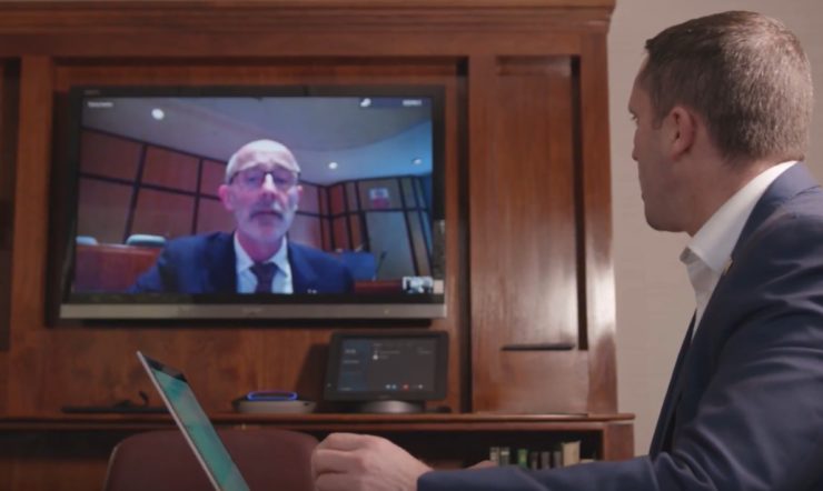 a man standing in front of a television