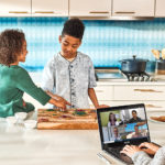a group of people sitting at a table with a laptop