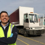 A man standing in front of a truck