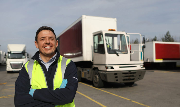 A man standing in front of a truck
