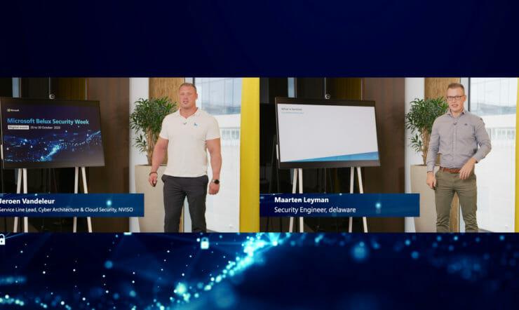 een groep mensen die zich voor een scherm bevinden