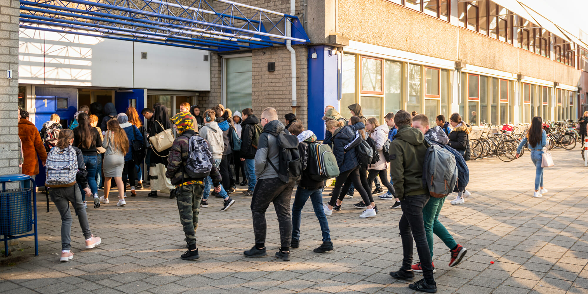 A group of students in front of a school