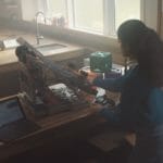 a person sitting at a desk in front of a computer