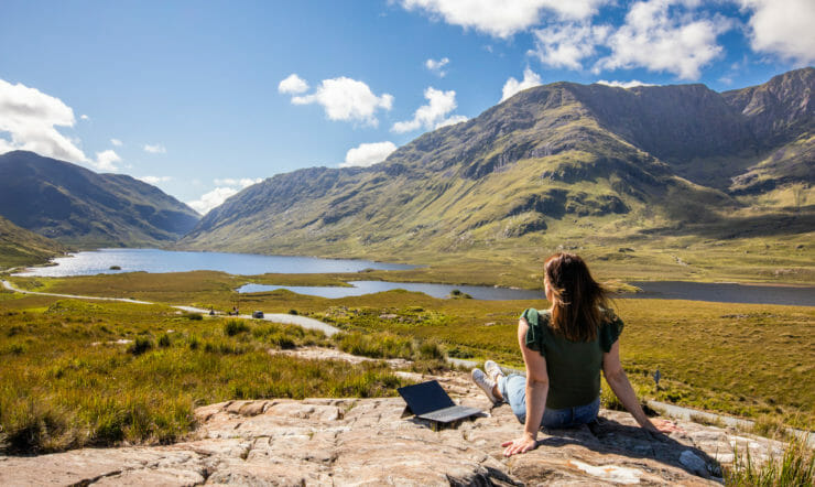 a person standing in front of a mountain