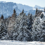 a man riding a snowboard down a snow covered mountain