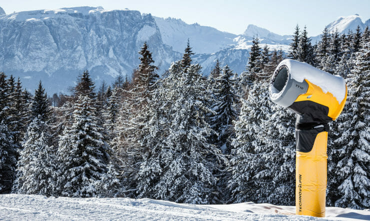 a man riding a snowboard down a snow covered mountain