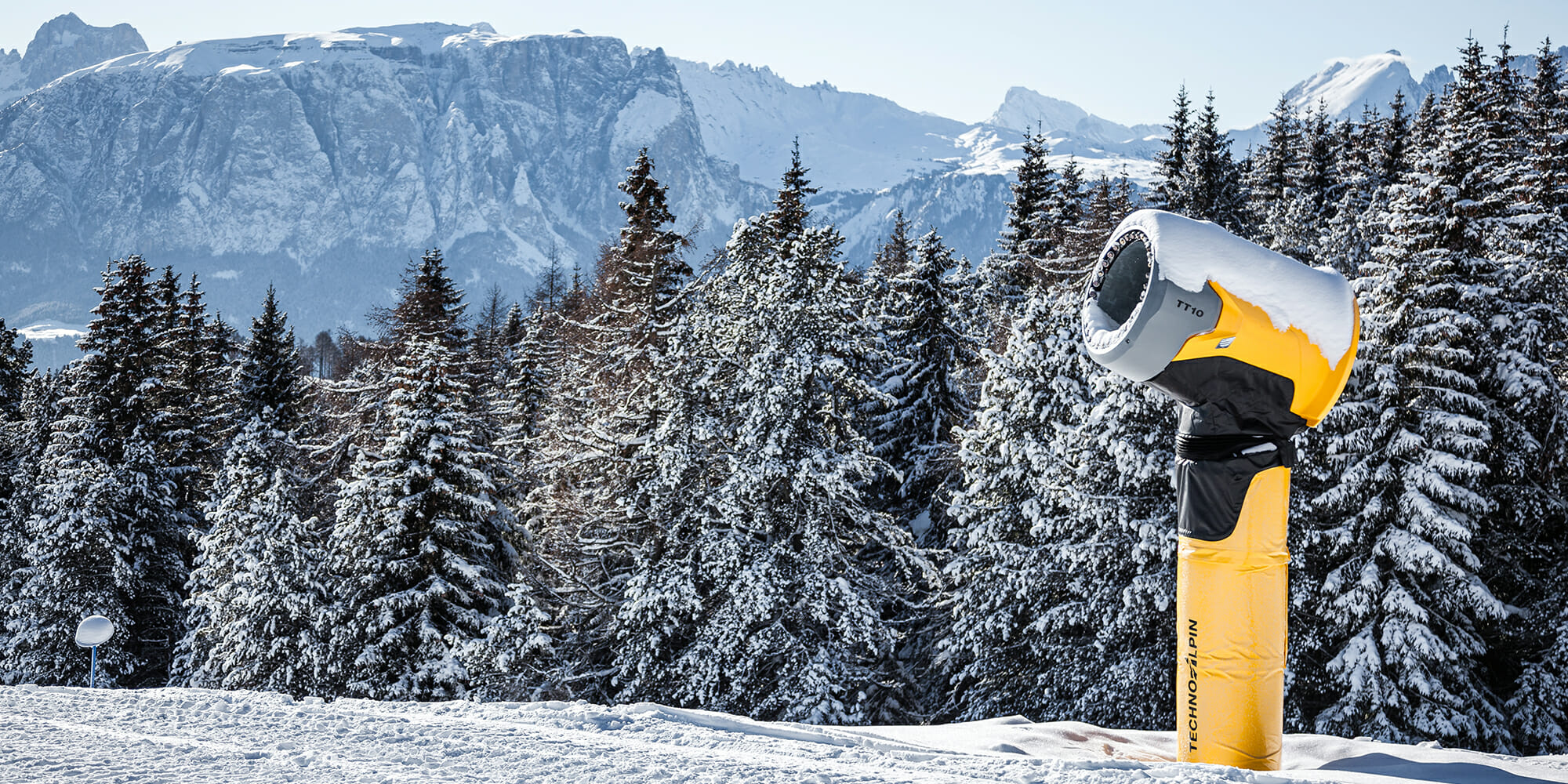 a man riding a snowboard down a snow covered mountain