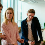 a group of people standing next to a person