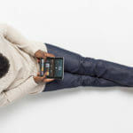 Adult male using Surface Duo in compose mode while listening to Spotify