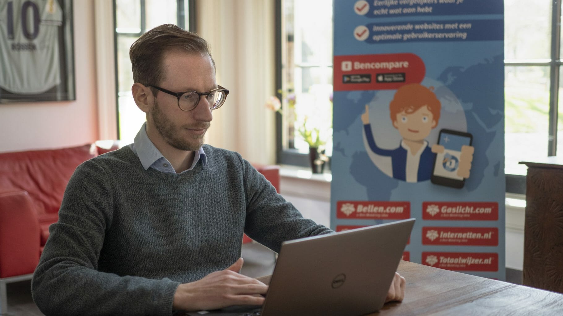 man in front of desk with laptop