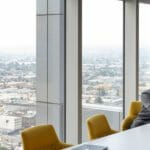 woman behind desk with skyline in background