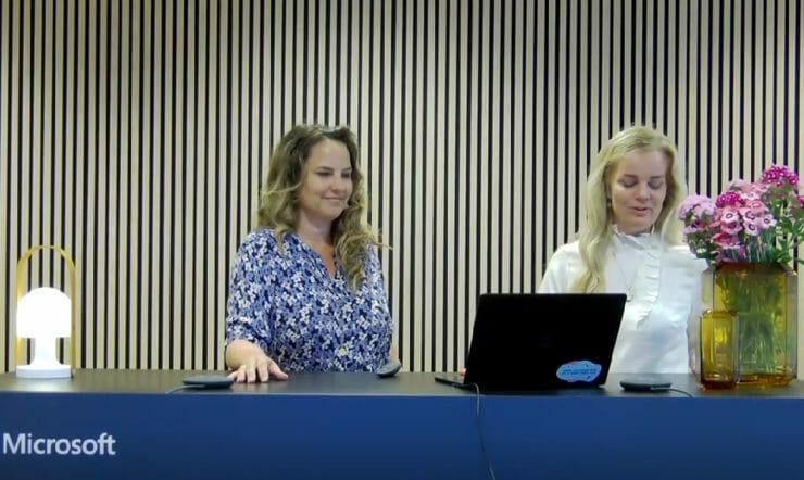 two women in front of a desk