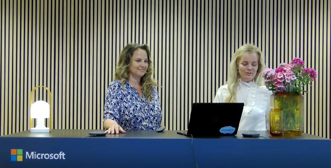 two women in front of a desk