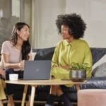 Employees collaborate in front of Surface devices