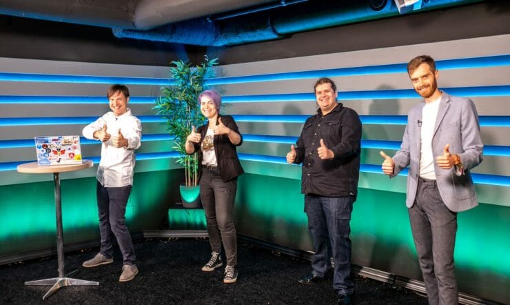 Maxim and guests in a studio giving the thumbs up