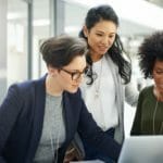 three women watching a computer