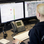 A person monitoring emergency calls using 