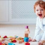A baby playing with toy blocks