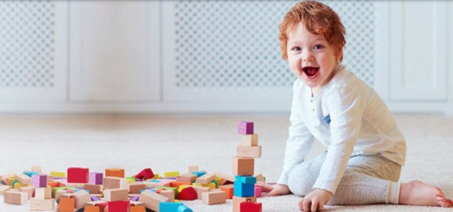 A baby playing with toy blocks