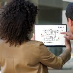 Woman and man with device