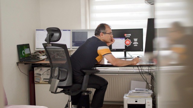 Ramazan in his home office