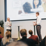 A woman and man standing on stage
