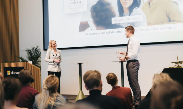 A woman and man standing on stage