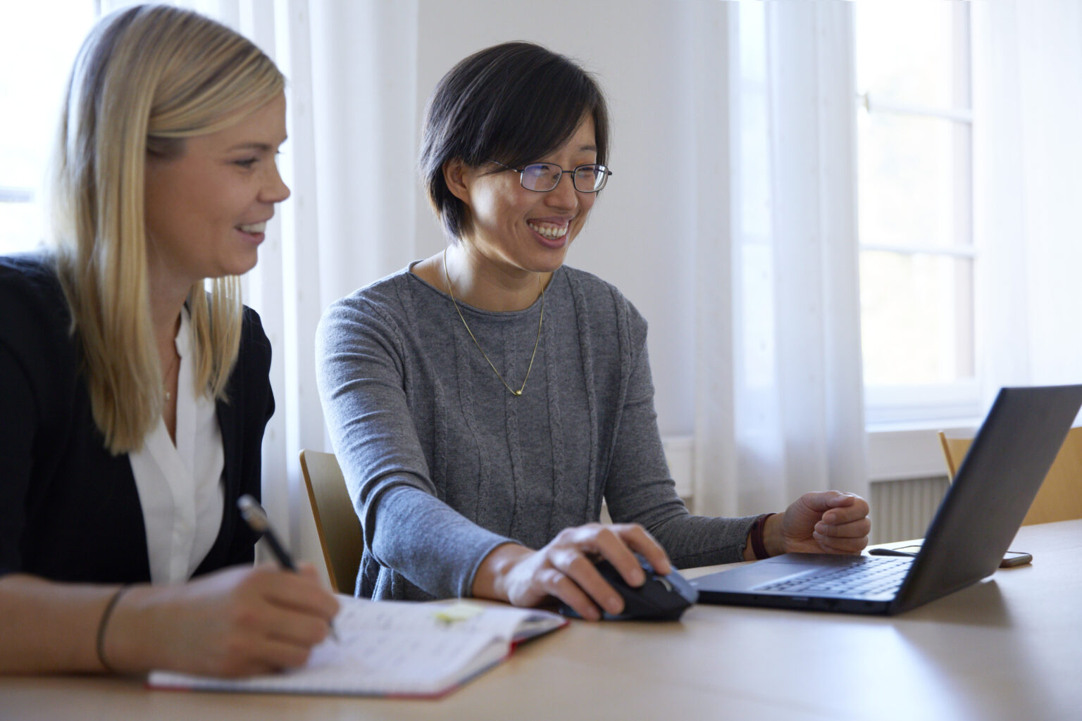 Two women in an office looking at a computer