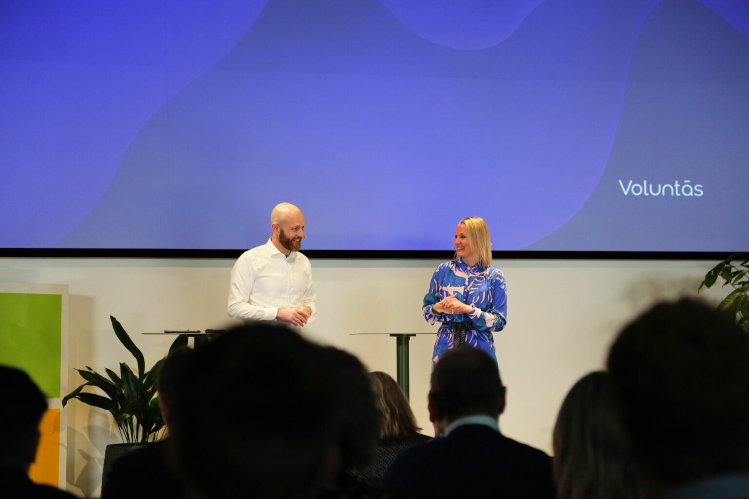 Two people on stage talking