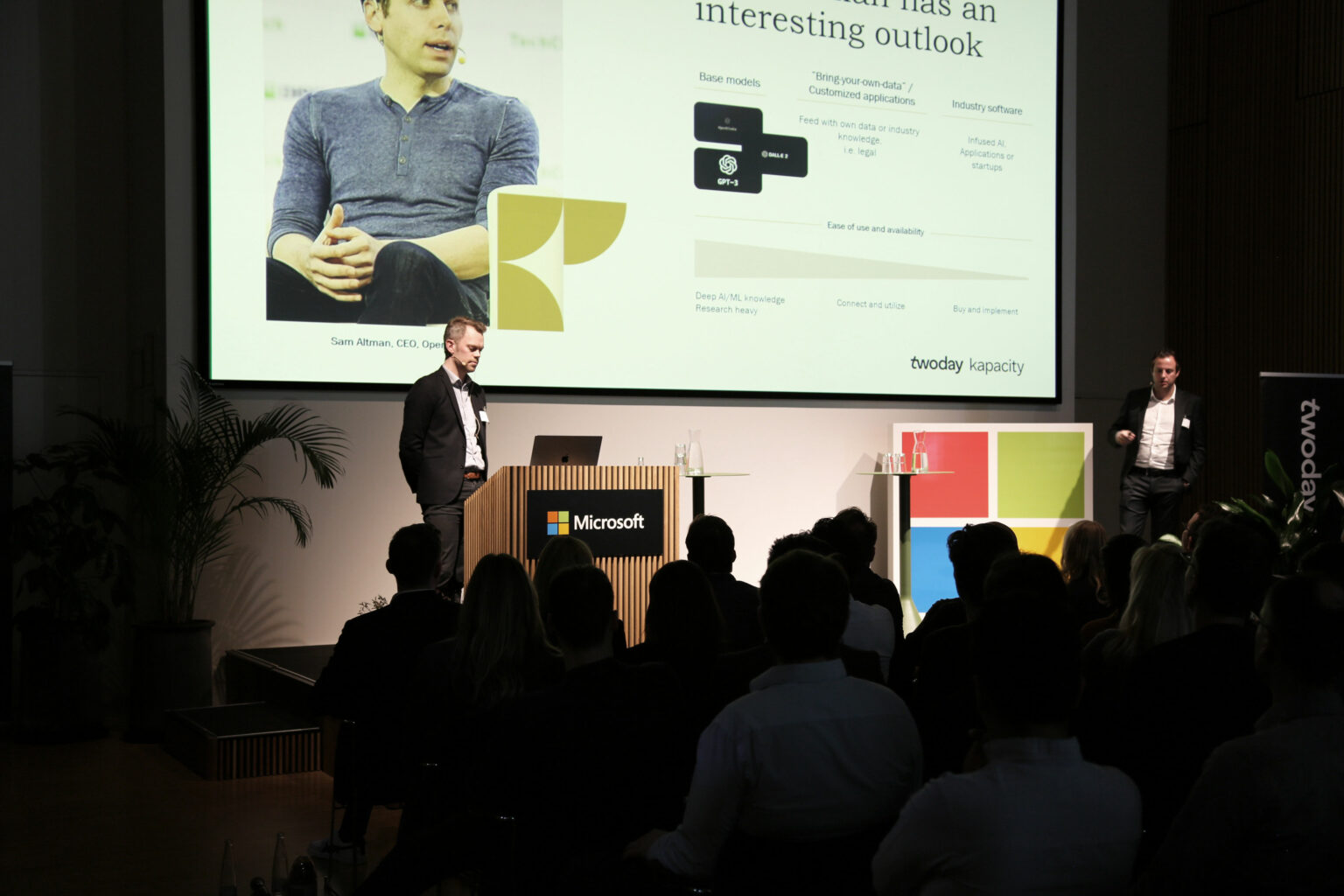 Two people on stage at Microsoft presenting