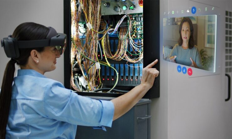 Woman interacing with Remote Assist hologram in a wiring project. Lifestyle photography. Contextual imagery.