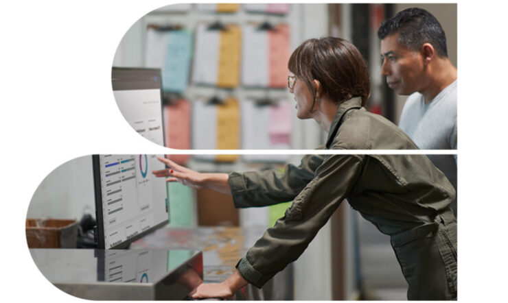 A man and a woman looking at a screen showcasing a dashboard