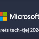 Image of one women and one man sitting with a computer 